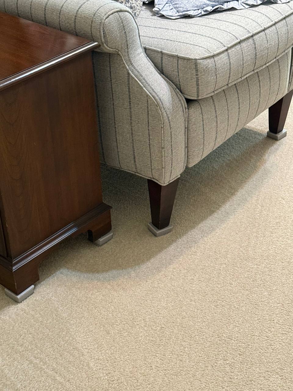 Freshly cleaned sofa resting on foam blocks to protect drying carpet beneath — Scott's Carpet Care in Humble, TX