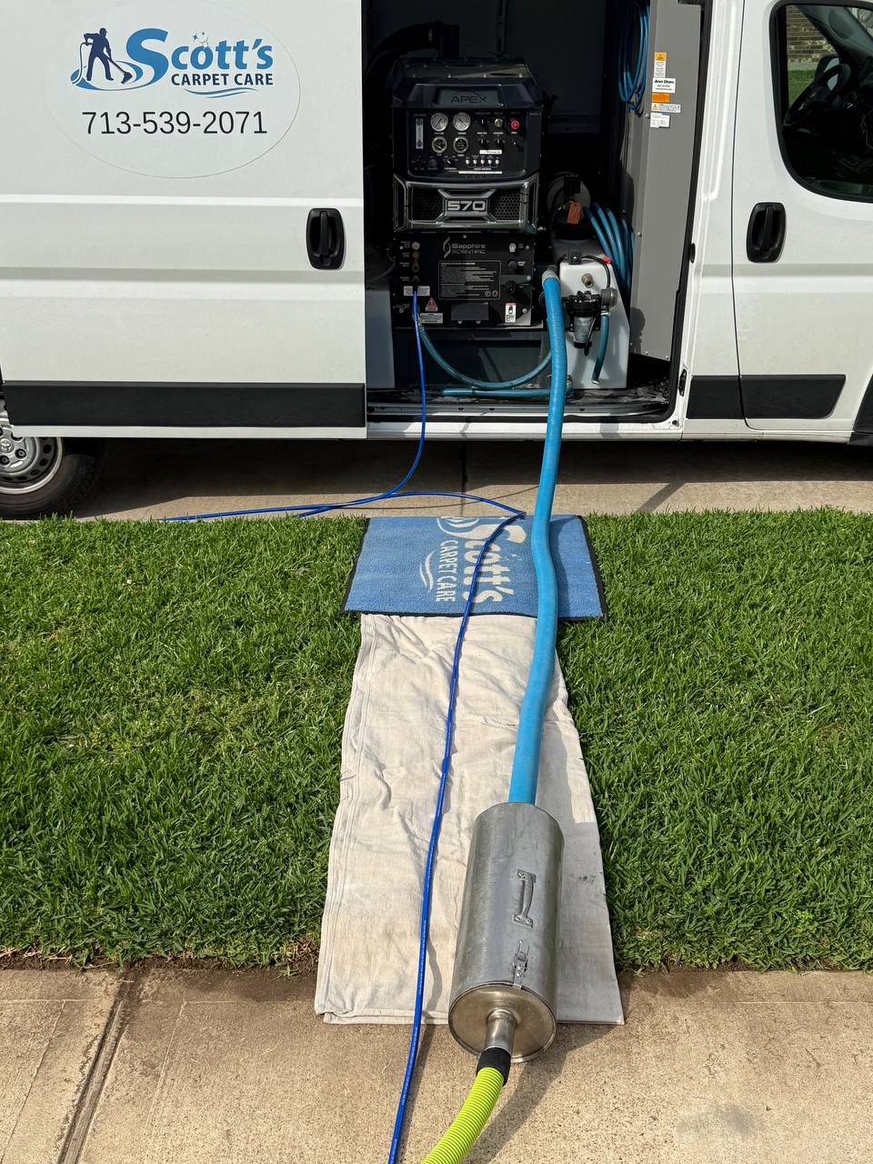 Scott's Carpet Care Sapphire 570 truck-mount setup with drop cloths protecting the grass at a Humble, TX home