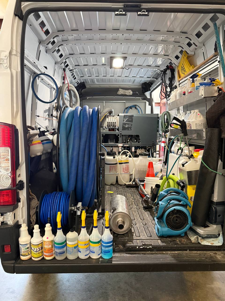 Inside of Scott's Carpet Care van showing pet-safe cleaning solution inventory